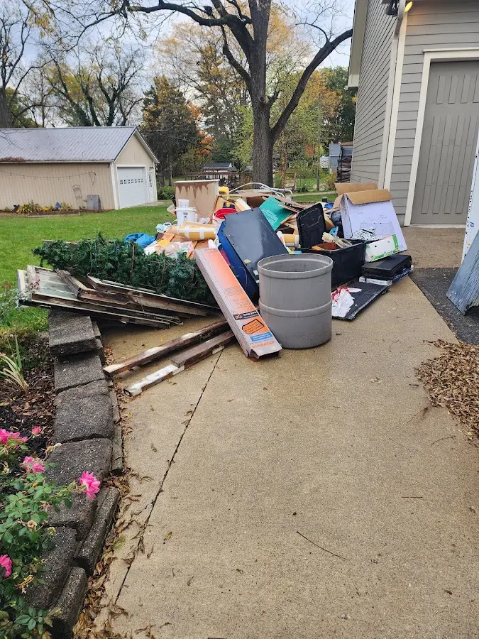 Dumpster being loaded with debris for Estate Cleanout Dumpster Rental in Candler-McAfee